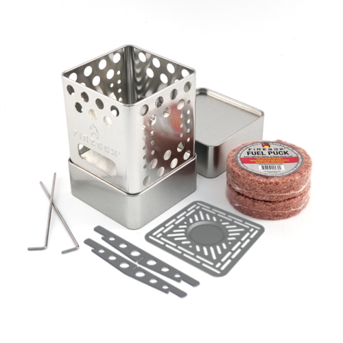 Photo of the Firebox Scout stove and performance kit, which includes 2 lids, Positioning Pins, Accelerator Cross Bars, Multi-Fuel Fire Grate, Stove case and 2 Fuel Pucks.